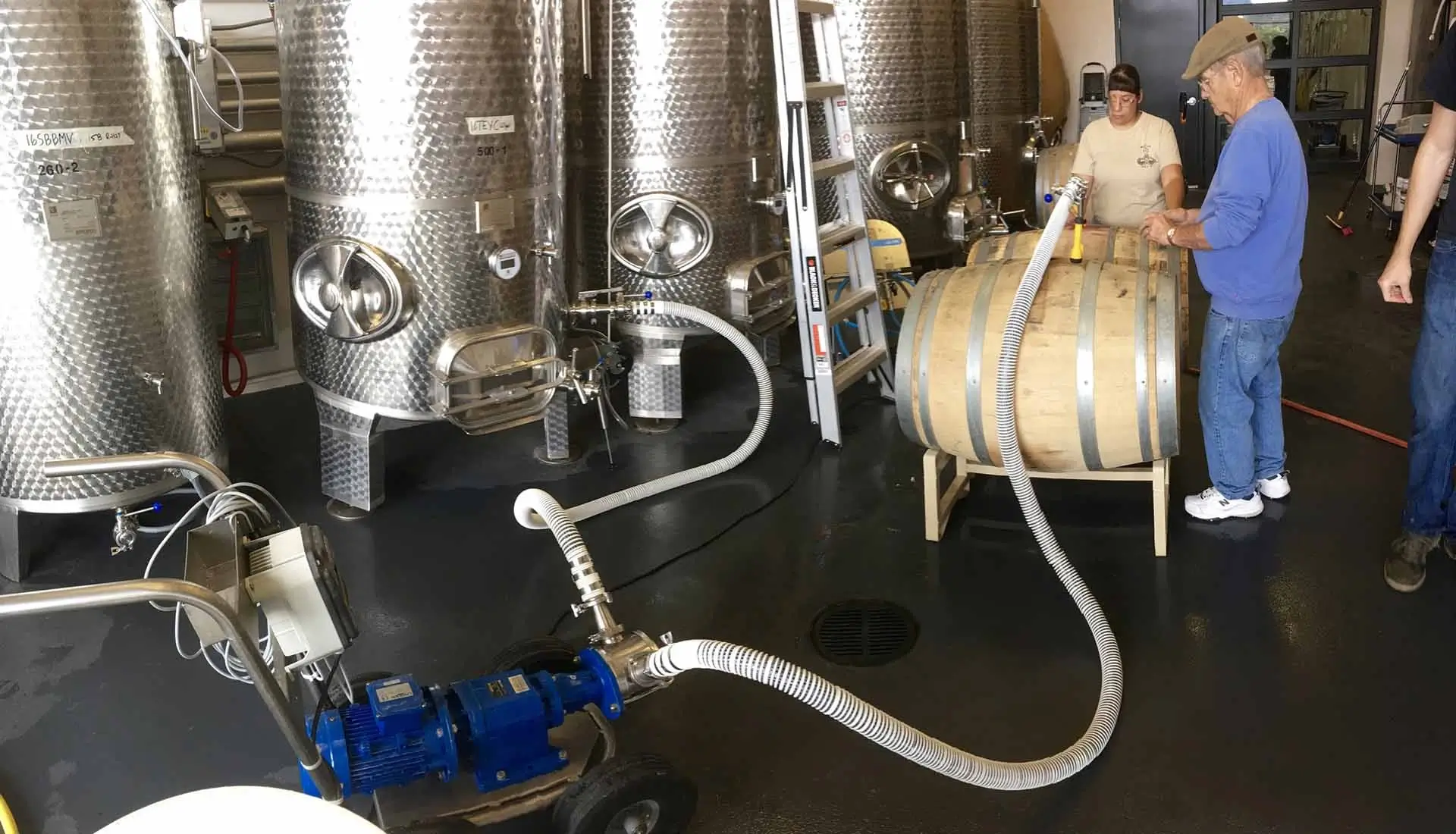 Commercial Winery Production Training Students working with wine barrels and fermentation tanks at Southwest Wine Center