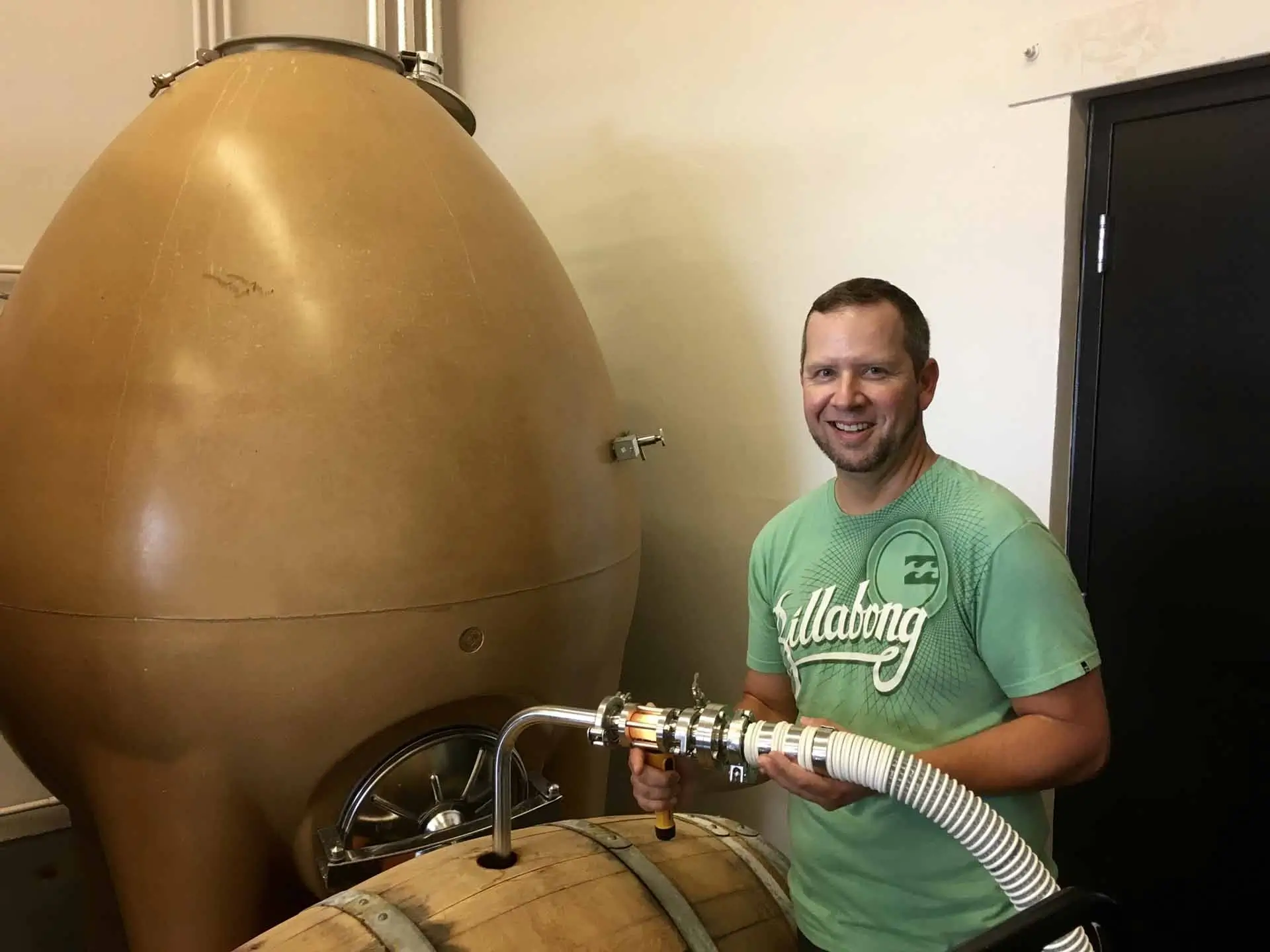 Hands-On Cellar Operations Student transferring wine from barrel using winery equipment at Southwest Wine Center